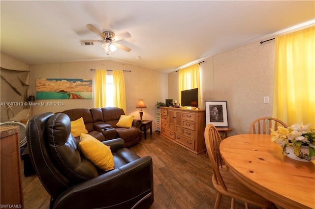 living room with dark hardwood / wood-style floors, ceiling fan, and vaulted ceiling