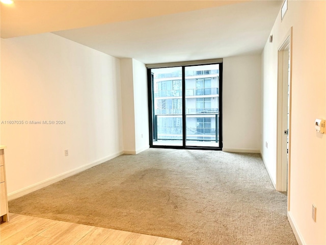 spare room featuring light hardwood / wood-style flooring