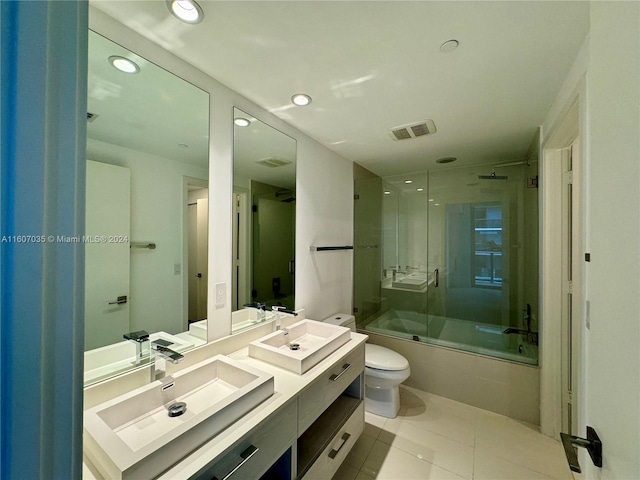 full bathroom with vanity, toilet, shower / bath combination with glass door, and tile patterned flooring