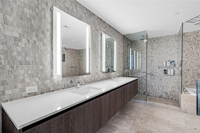 bathroom featuring tile floors, dual sinks, tile walls, and large vanity