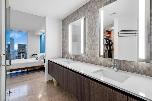 bathroom with backsplash, dual vanity, and tile flooring