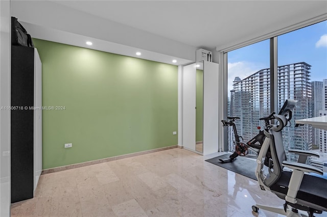 unfurnished office featuring tile flooring and a wall of windows