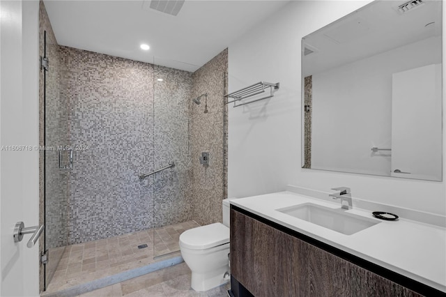 bathroom featuring walk in shower, vanity, toilet, and tile floors