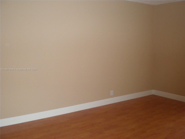 unfurnished room featuring wood-type flooring