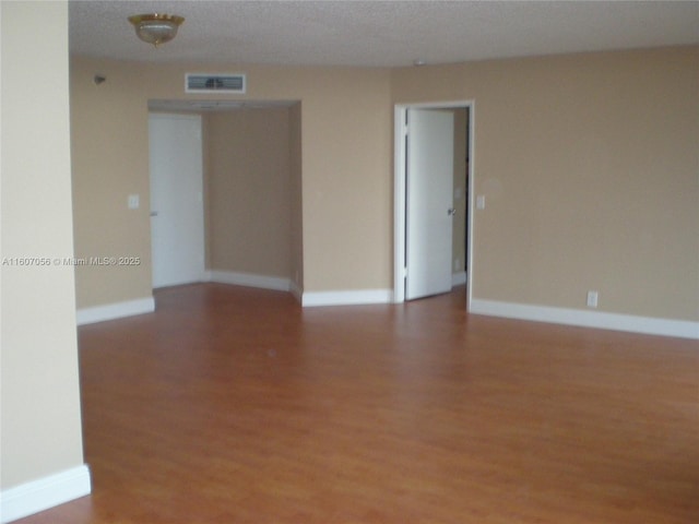 empty room featuring wood-type flooring