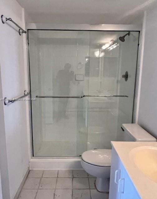 bathroom with vanity, an enclosed shower, and toilet