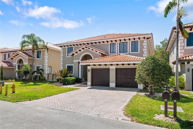 mediterranean / spanish house featuring a garage and a front lawn