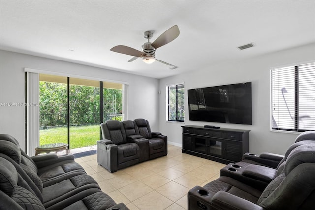 living room featuring ceiling fan and light tile patterned flooring