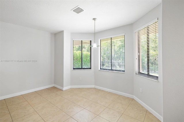 empty room with light tile patterned flooring