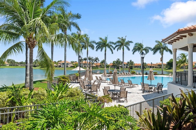 view of pool with a patio area and a water view