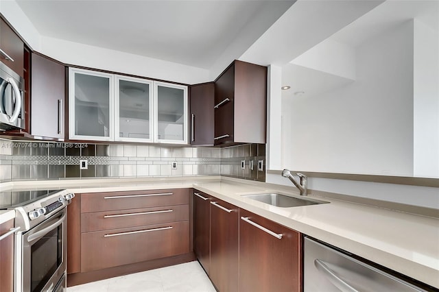 kitchen featuring sink, dark brown cabinets, light tile patterned floors, stainless steel appliances, and decorative backsplash