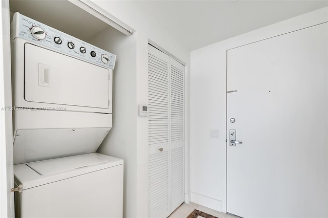 clothes washing area with stacked washer and clothes dryer