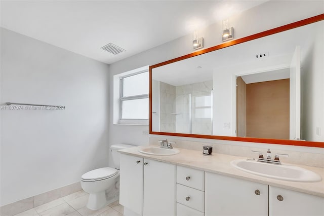 bathroom with vanity, tile patterned flooring, toilet, and walk in shower