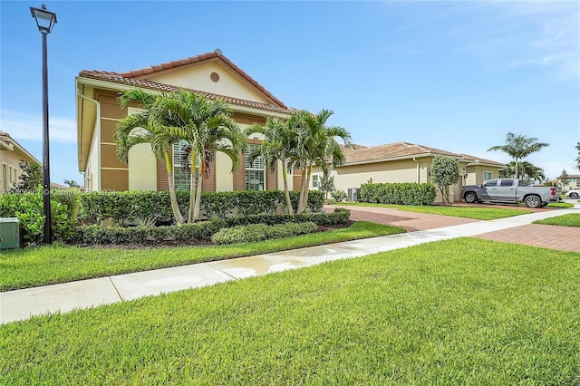 mediterranean / spanish-style home featuring a front lawn