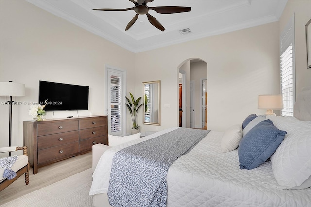 bedroom with crown molding, ceiling fan, and light wood-type flooring