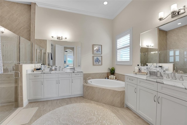 bathroom featuring crown molding, separate shower and tub, and vanity