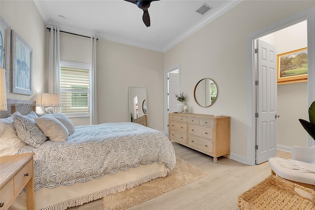 bedroom with ceiling fan, ornamental molding, and light hardwood / wood-style flooring