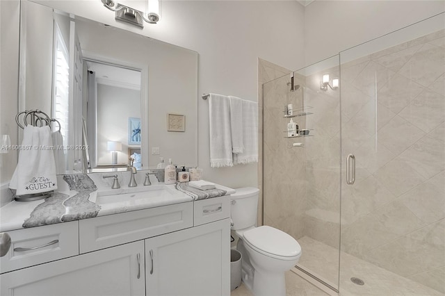 bathroom featuring vanity, a shower with door, and toilet