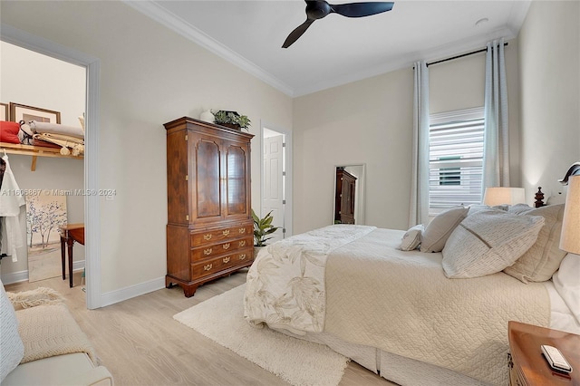 bedroom with crown molding, ceiling fan, and light hardwood / wood-style floors