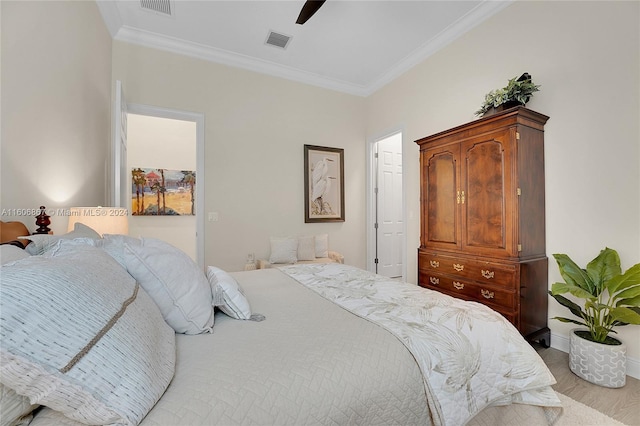 bedroom with ornamental molding, light wood-type flooring, and ceiling fan