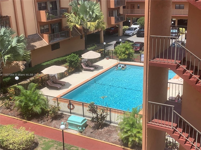 view of pool featuring area for grilling and a patio area