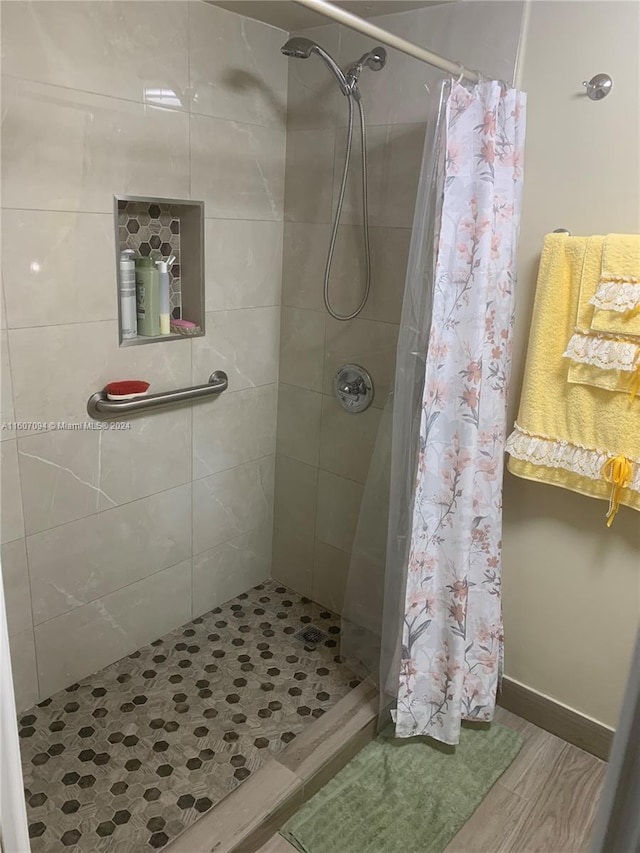 bathroom featuring a shower with curtain and hardwood / wood-style flooring