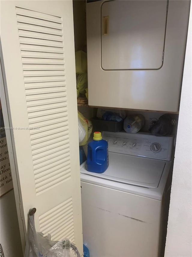 laundry room with stacked washer / dryer