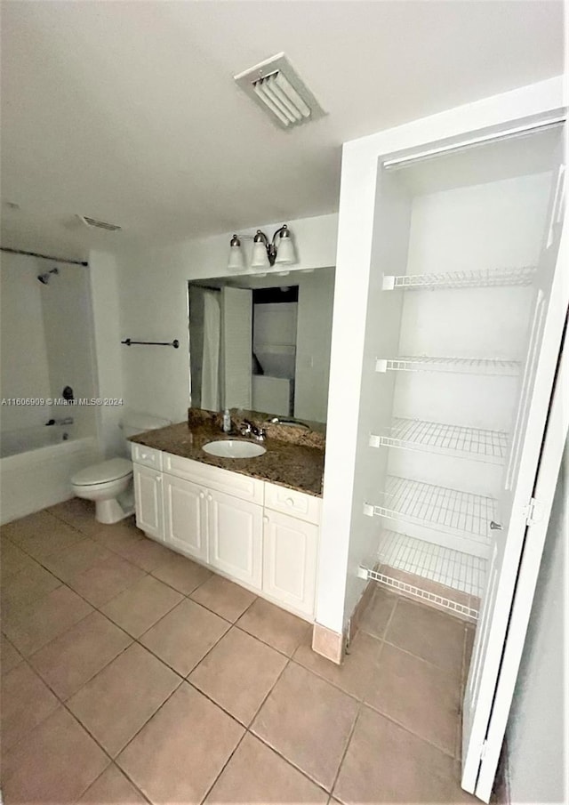 full bathroom featuring tile patterned flooring, vanity, toilet, and bathtub / shower combination