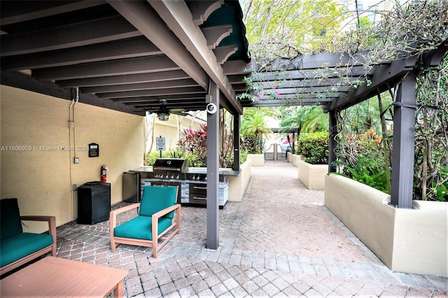 view of patio / terrace with an outdoor kitchen, ceiling fan, a pergola, and area for grilling