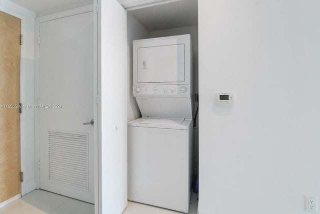 laundry area featuring stacked washing maching and dryer and laundry area