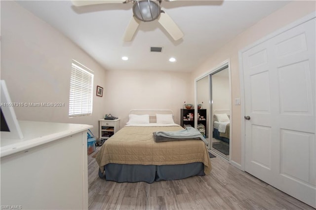 bedroom with recessed lighting, wood finished floors, a ceiling fan, visible vents, and a closet