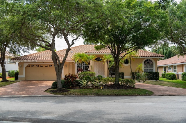 mediterranean / spanish house featuring a garage