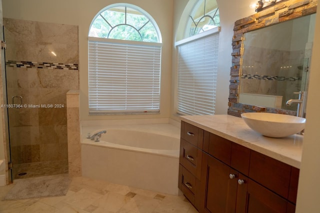 bathroom with separate shower and tub, vanity, and tile floors