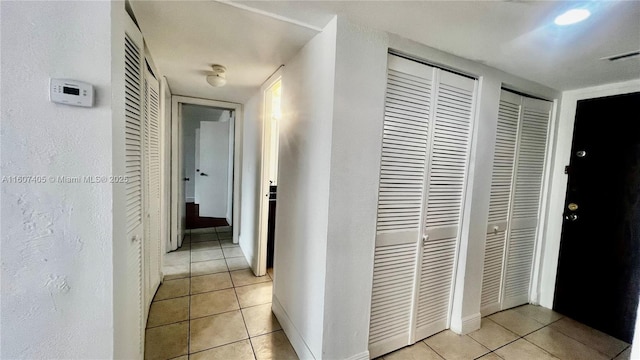 corridor featuring light tile patterned floors