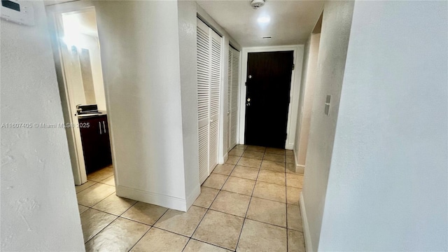 corridor with light tile patterned flooring