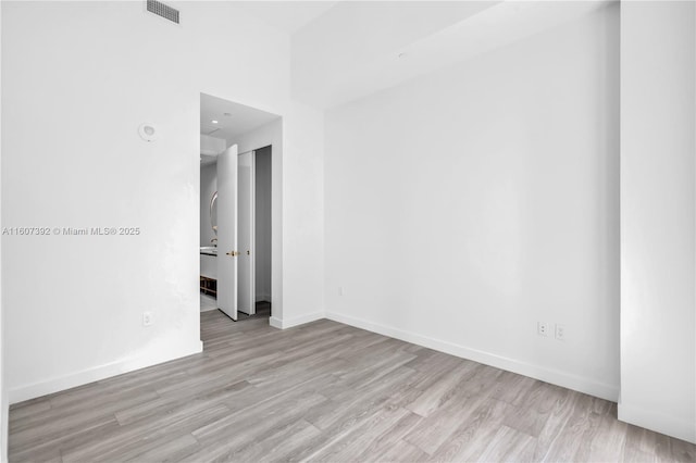 spare room with light wood-type flooring