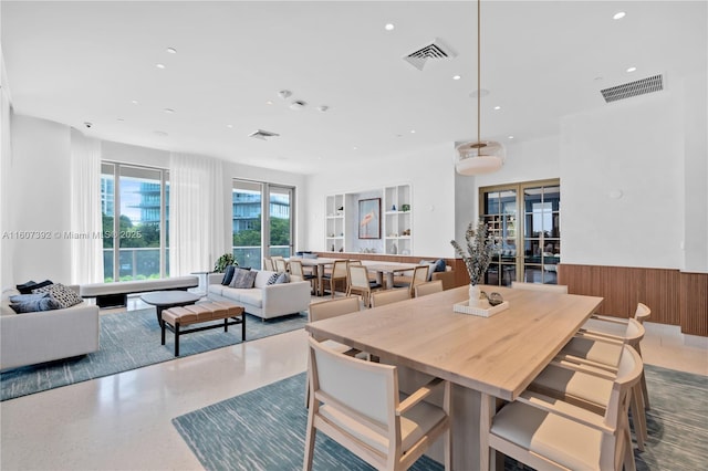 dining room with wood walls