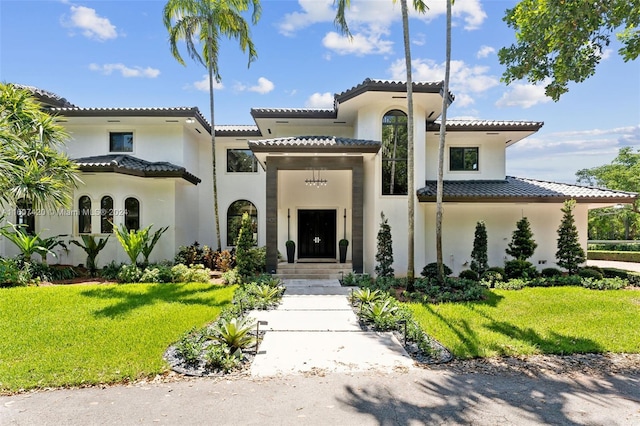 mediterranean / spanish-style home featuring a front yard