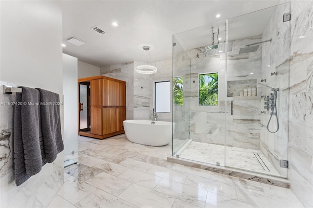 bathroom featuring shower with separate bathtub