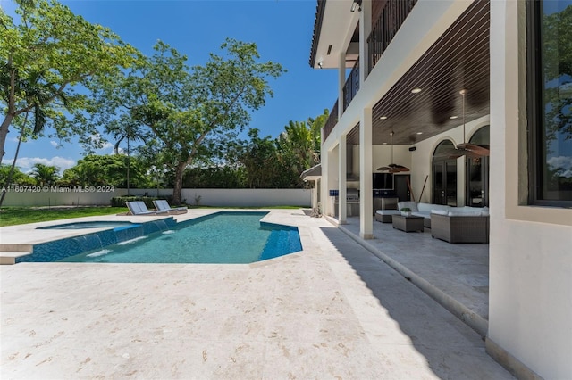 view of pool with outdoor lounge area, ceiling fan, a patio area, an in ground hot tub, and area for grilling