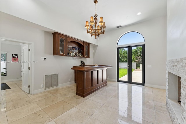 interior space featuring french doors and an inviting chandelier