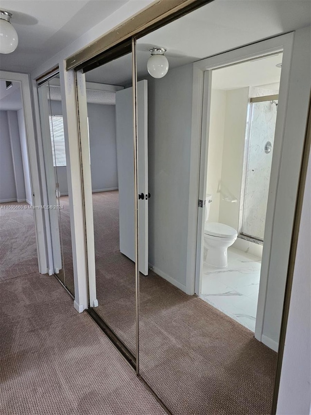 hallway with baseboards, marble finish floor, and carpet flooring