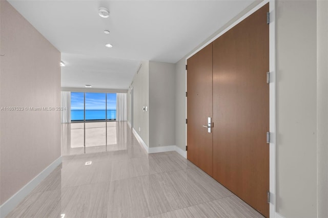 hall featuring light tile patterned flooring