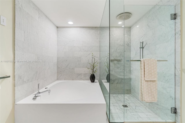 bathroom featuring shower with separate bathtub