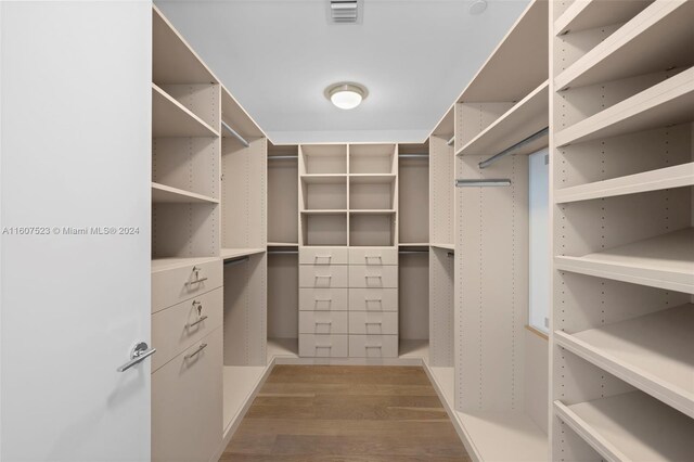 spacious closet featuring hardwood / wood-style flooring