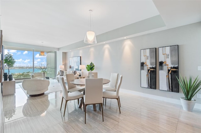 tiled dining room with a water view