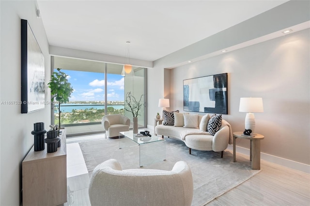 living room with a water view and hardwood / wood-style floors