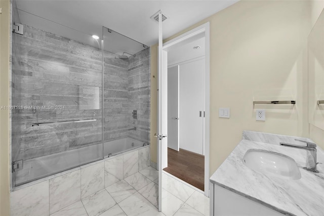 bathroom featuring vanity, tile patterned floors, and tiled shower / bath