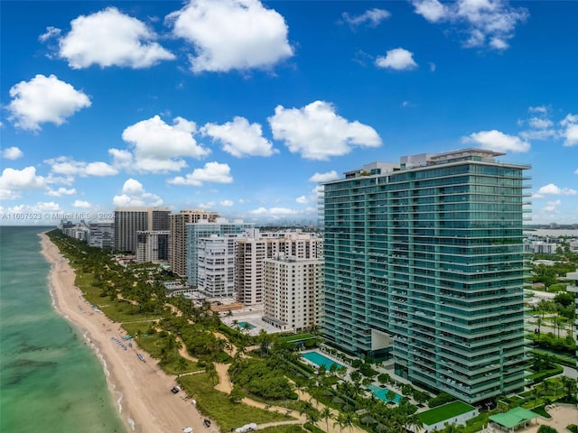 view of building exterior with a water view and a beach view