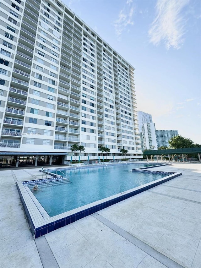 view of swimming pool featuring a patio area